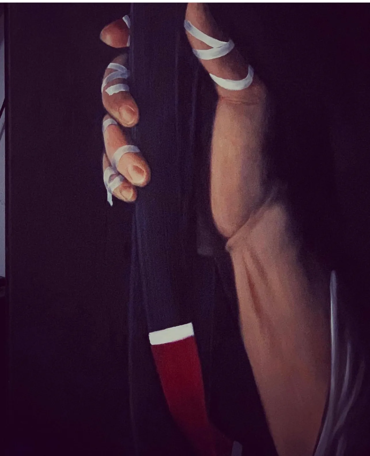 A close-up oil painting of a fighters taped hands gripping a jiu jitsu black belt before a match.