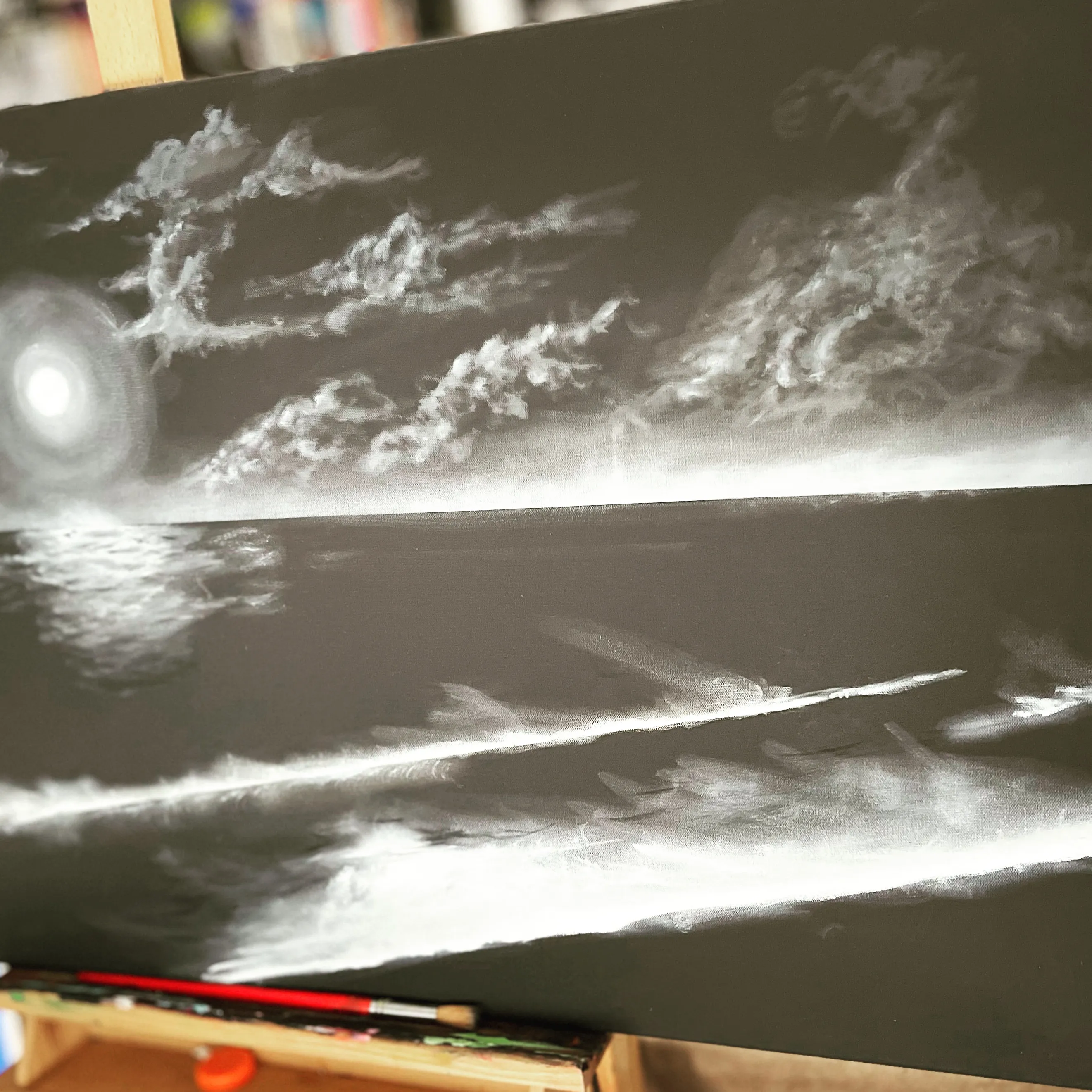 A grayscale painting of moonlight reflecting across ocean waves at night.